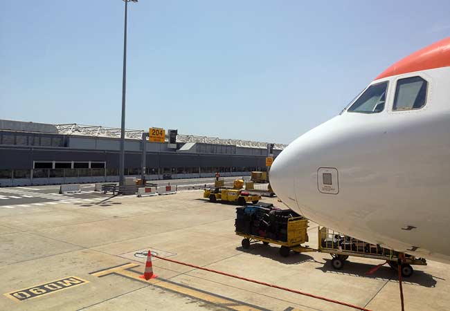 plane parked in front of terminal 2